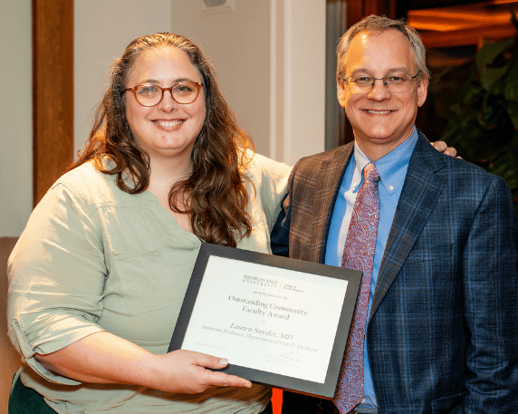 Lauren Snyder, MD accepting the award from Dean Sousa.