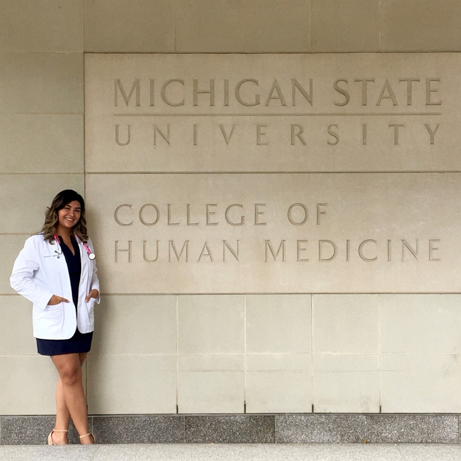Medical student stands in front of Secchia Center