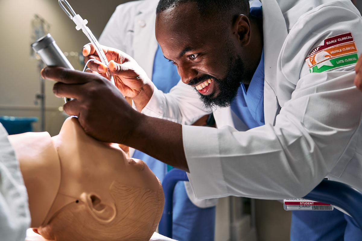 Med student performing a simulated examination.