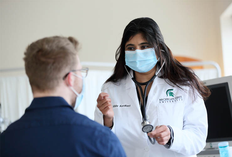 Patient being consulted by medical student.