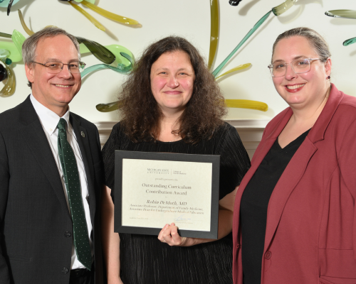 Robin DeMuth, MD,  posed with dean Sousa and their department chair.