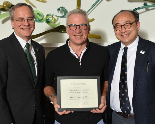 Gary Ferenchick, MD,  posed with dean Sousa and their department chair.