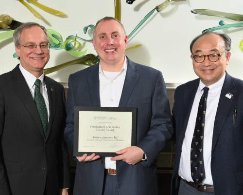 Andrew Johnson, MD,  posed with dean Sousa and their department chair.