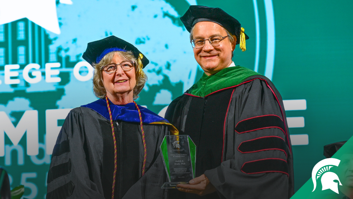 Judy Brady receiving the Lifetime Faculty Excellence in Teaching Award from the College of Human Medicine dean Aron Sousa.