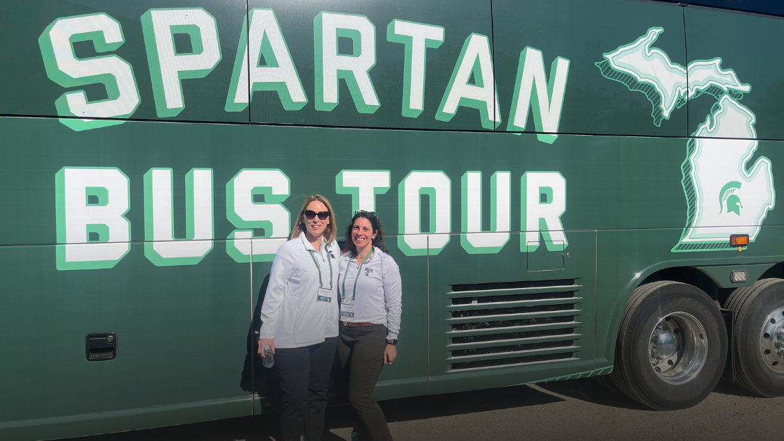 Erika Rosebrook, Interim Director of the Master in Public Policy Program and Felicia Eshragh, in front of the Spartan Bus Tour bus.