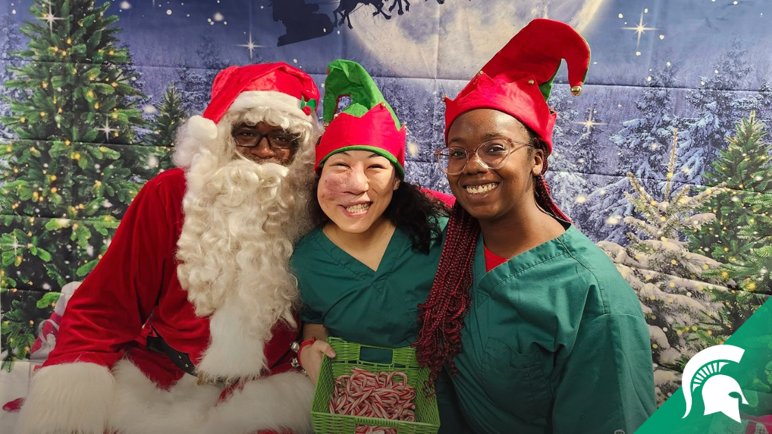 Todd McHerron, MD, dressed as santa, with Michelle Lai and Elizabeth Shokoya, who are dressed as elves.