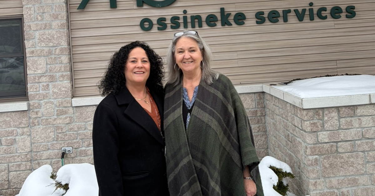 Jane Hiske and Sandy Samp standing in front of a building.