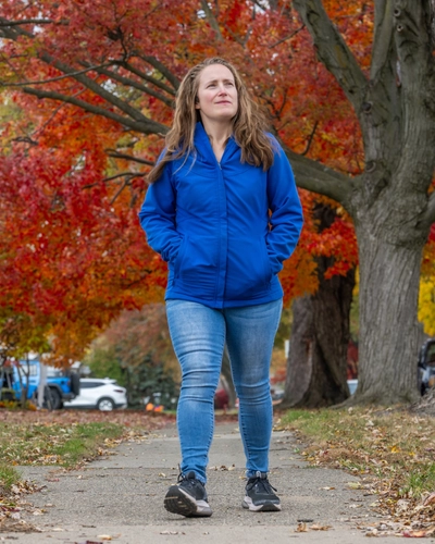 Gabrielle Ekstrum walking along a sidewalk.