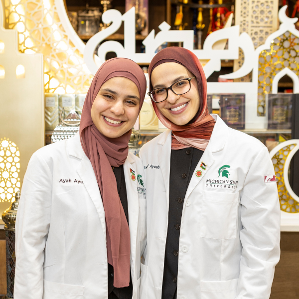 Awatef and Ayah Ayesh at the supergreen market in their white coats.