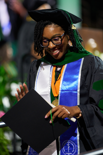 commencement-2026-grad-smiling.png