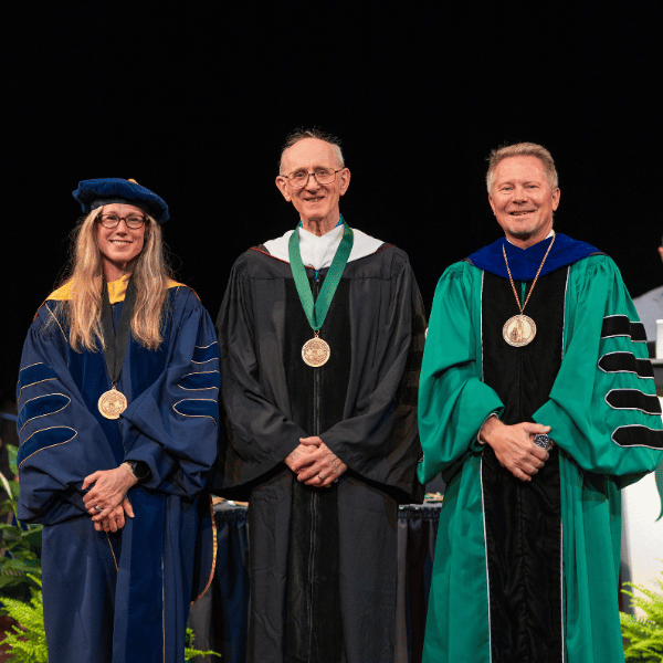 Ted Miller, center, with the provost and president at the 2026 investiture.