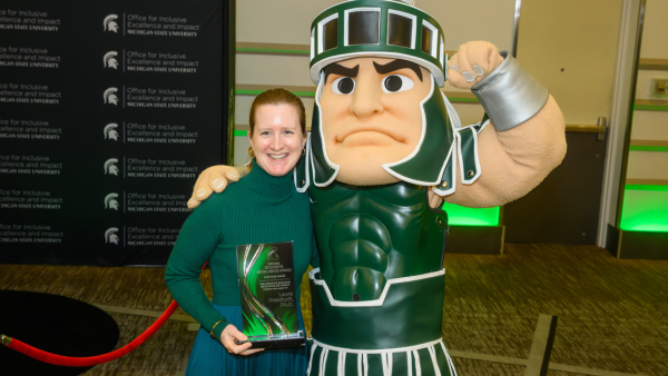 Laura Freidhoff, MD, at the MSU Inclusive Excellence awards with Sparty.