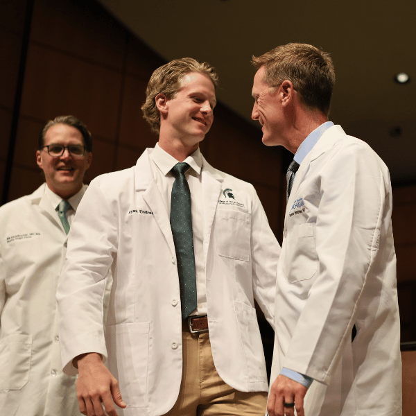 Ryan Endres smiling with his father after being coated.