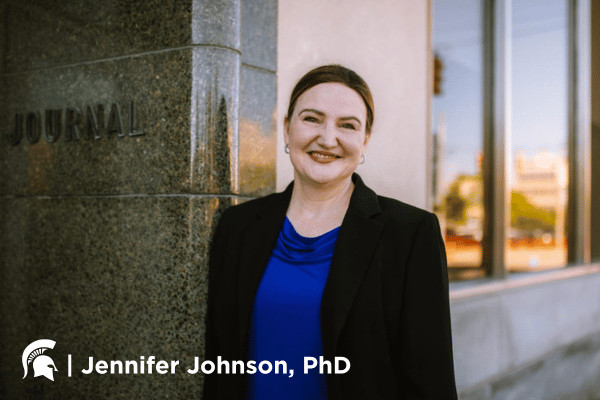 Jennifer Johnson in front of MSU Flint campus building.