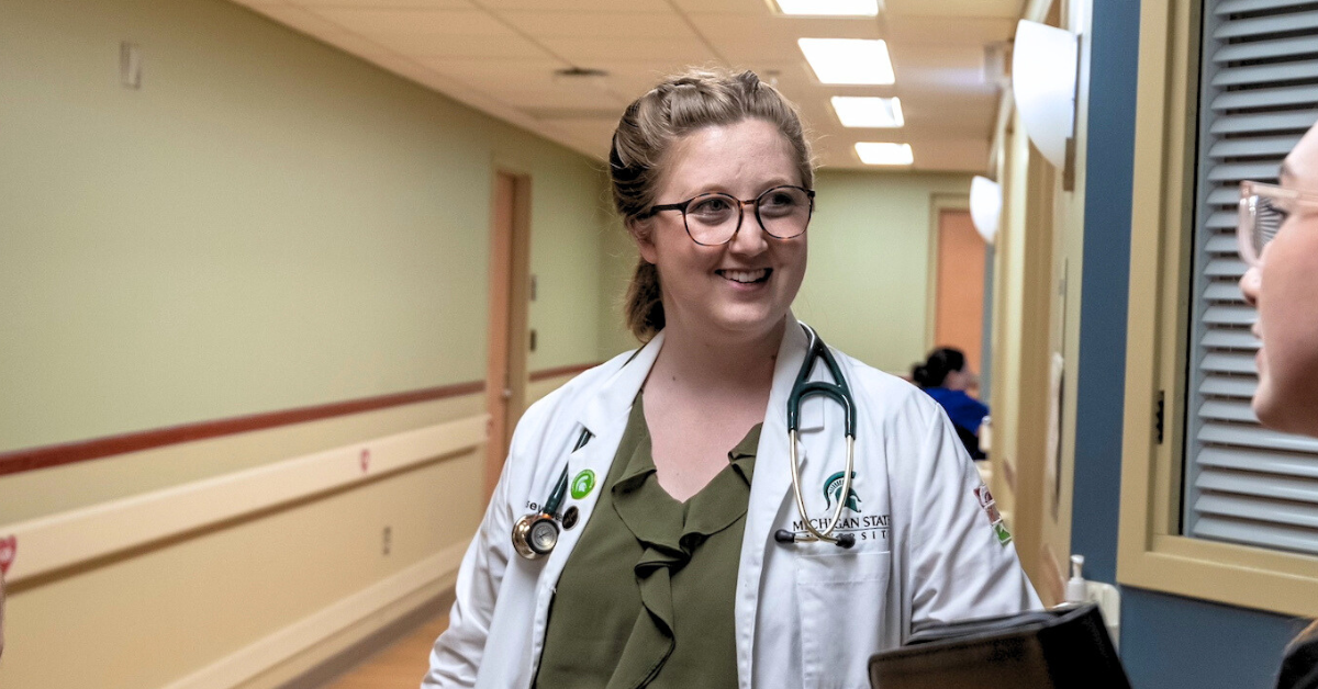 Kelsey Bean in the Midland campus talking with a patient.