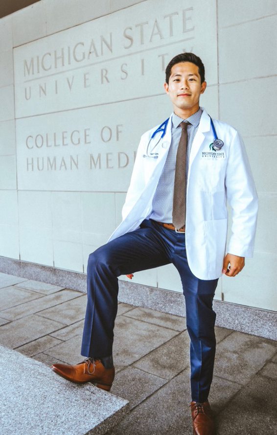 Kelvin Lim in front of the MSU College of Human Medicine sign.