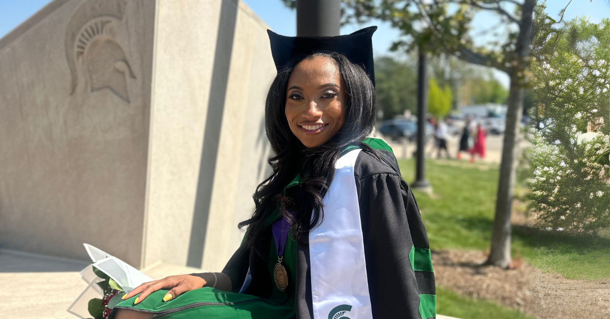 Kyra Orton posed outside of the Breslin Center after graduation.