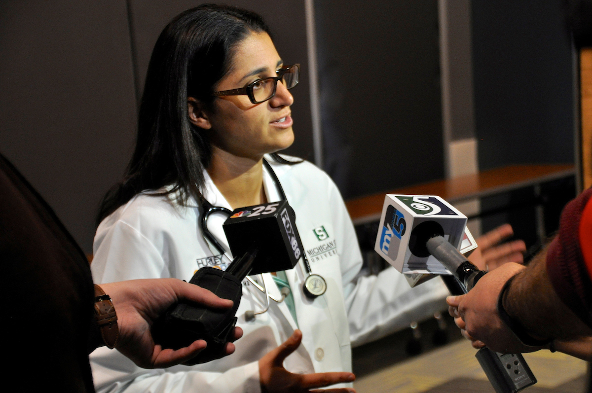 Dr. Mona examining a young patient