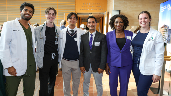 Dean Rayamajhi with a group of people at the Secchia Center 15th celebration.