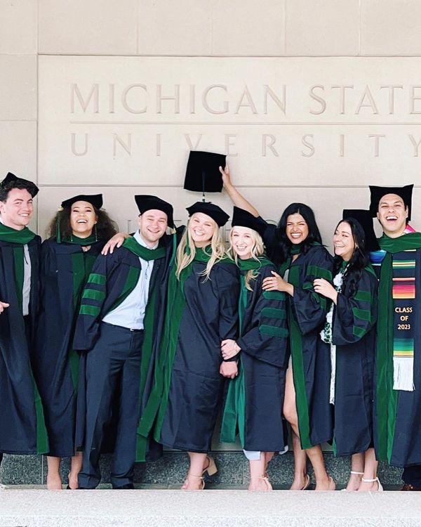 A group of College of Human Medicine graduates celebrating during commencement.